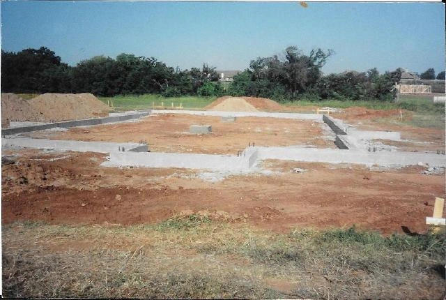 Concrete foundation footings in a field.