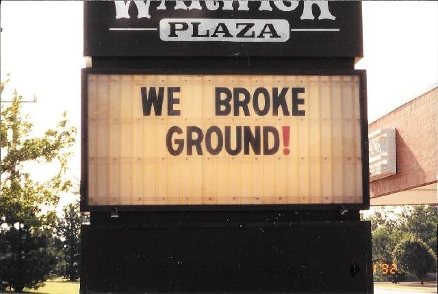 Plaza sign reading "WE BROKE GROUND!"
